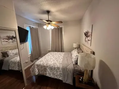 a bedroom with a bed and a ceiling fan at Casa Yael in West New York