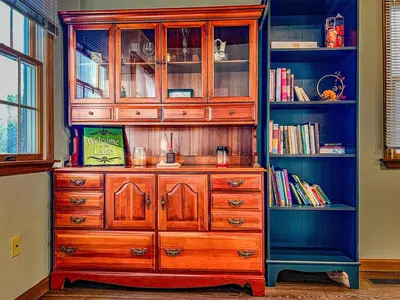 a wooden dresser in a room with a book shelf at Private, Family-Friendly Home Near Candlewood Lake in New Fairfield
