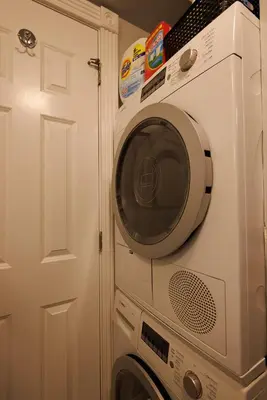 a washing machine in a room with a door at Urban Oasis 1BR East Village Hideaway with Patio! in New York
