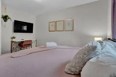 a bedroom with a bed and a desk and a television at 5 min Shawnee Mountain, Hot tub, Game Rm, 3 Kings in East Stroudsburg
