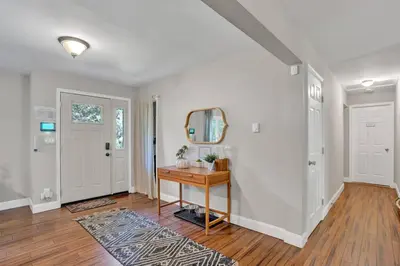 a home hallway with a table and a mirror at 5 min Shawnee Mountain, Hot tub, Game Rm, 3 Kings in East Stroudsburg