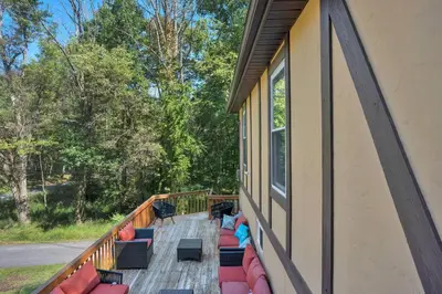 a balcony with red and blue couches on a house at 5 min Shawnee Mountain, Hot tub, Game Rm, 3 Kings in East Stroudsburg