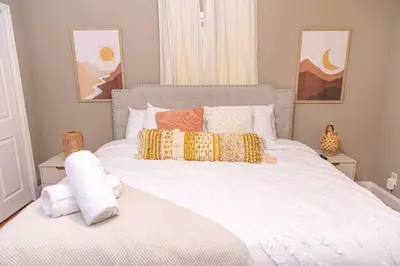 a bedroom with a large white bed with pillows at 5 min Shawnee Mountain, Hot tub, Game Rm, 3 Kings in East Stroudsburg