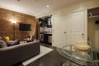 a living room with a couch and a glass table at Refined & Stylish Manhattan Haven in New York