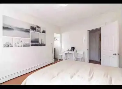 a large white bedroom with a large white bed at New York Flushing private room in Flushing