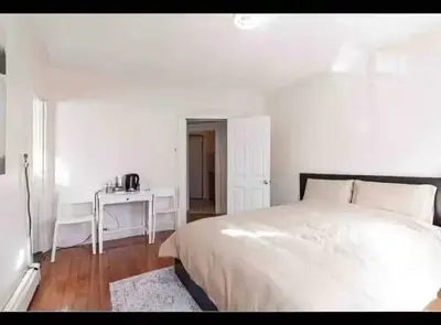 a white bedroom with a large bed and a desk at New York Flushing private room in Flushing