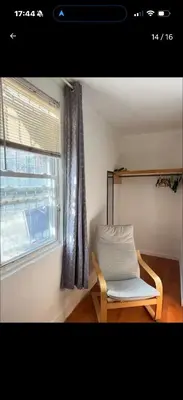 a chair sitting in a room with a window at New York Flushing private room in Flushing