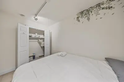 a bedroom with a white bed and a closet at The NYC Edition Times Square in New York
