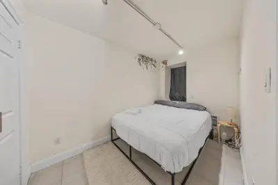 a bedroom with a bed in a white room at The NYC Edition Times Square in New York