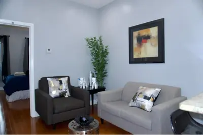 a living room with a couch and a chair at New York private room 29 in West New York