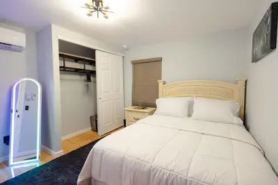 a bedroom with a bed with a white bedspread at Bear Trails Retreat-Pocono Getaway Near Kalahari in Pocono Summit