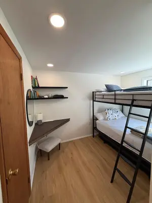 a dorm room with a desk and bunk beds at A-Frame Chalet Ski Lodge Near Shawnee in East Stroudsburg