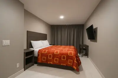 a bedroom with a bed and a television in it at Hotel Fuego Bronx near Yankee Stadium in Bronx