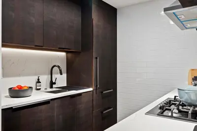 a kitchen with wooden cabinets and a sink at Modern 2BR Brooklyn Retreat Near Manhattan with Private Backyard in Brooklyn