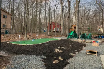 a miniature golf course in a park with a playground at Luxury Pocono Escape ~ Sauna | Hot Tub | Mini Golf in Tobyhanna