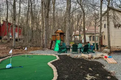 a golf course with a putting green and a playground at Luxury Pocono Escape ~ Sauna | Hot Tub | Mini Golf in Tobyhanna