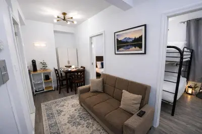 a living room with a couch and a bedroom at JC Central Stylish Stay Near Manhattan 1A in Jersey City