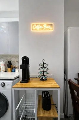 a kitchen with a coffee maker and a christmas tree on a table at JC Central Stylish Stay Near Manhattan 1A in Jersey City