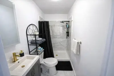 a bathroom with a shower and a toilet and a sink at JC Central Stylish Stay Near Manhattan 1A in Jersey City