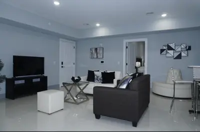 a living room with a couch and a tv at Big apple room 35 in West New York