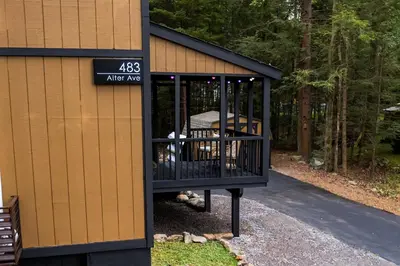 a dog in a cage in the side of a building at Deer Trails Retreat -Pocono Getaway Near Kalahari in Pocono Summit