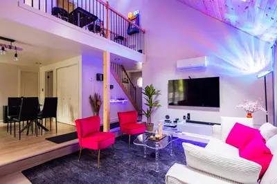 a living room with a white couch and red chairs at Deer Trails Retreat -Pocono Getaway Near Kalahari in Pocono Summit