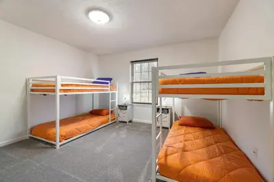 a room with three bunk beds in it at The Aerie House In Tobyhanna in Tobyhanna