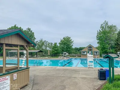 a swimming pool at a resort with a playground at The Aerie House In Tobyhanna in Tobyhanna