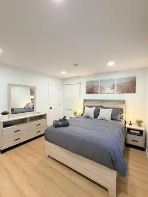 a bedroom with a large bed and a television at 35 to NYC - Netflix - 2Beds -1BR - FIFA 2026 in Passaic