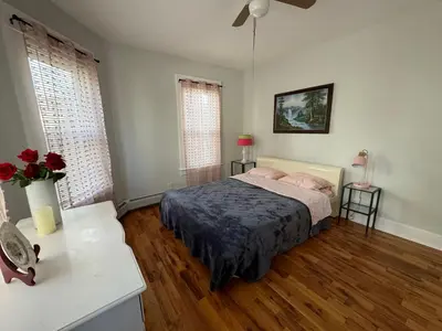 a bedroom with a bed and two windows at 3-bedroom peaceful apartment close to Fairfield University in Fairfield