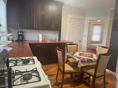 a kitchen with a stove and a table with chairs at 3-bedroom peaceful apartment close to Fairfield University in Fairfield