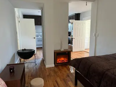 a bedroom with a bed and a fireplace in a room at 3-bedroom peaceful apartment close to Fairfield University in Fairfield