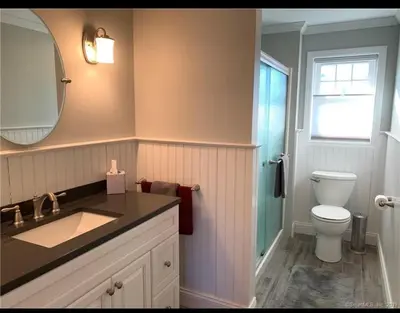 a bathroom with a sink and a toilet and a mirror at Stratford Getaway in Stratford