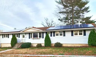 a white house with solar panels on the roof at Stratford Getaway in Stratford