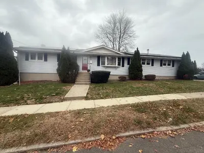 a white house with a red door at Stratford Getaway in Stratford