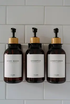 a group of three bottles of soap on a shelf at 2BR City Getaway - Close to NYC - Prime Location in Hoboken