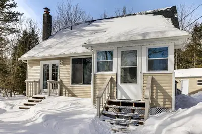 a small house with snow on the roof at Steps to Lake! Family Haven with Hot Tub in Poconos in Tobyhanna