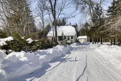 a house is covered in snow at Steps to Lake! Family Haven with Hot Tub in Poconos in Tobyhanna