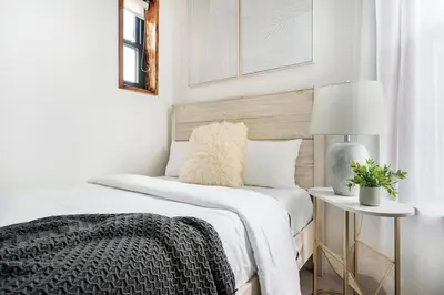 a white bedroom with two beds and a lamp at 48-4FE 2BR Prime Midtown West in New York