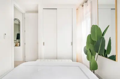 a bedroom with a white bed and a plant at 48-4FE 2BR Prime Midtown West in New York