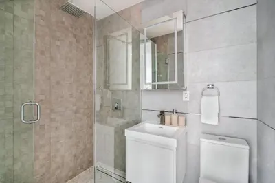 a bathroom with a shower and a toilet and a sink at 317-4B Brand New Modern 1BR Union Square WD in Unit in New York