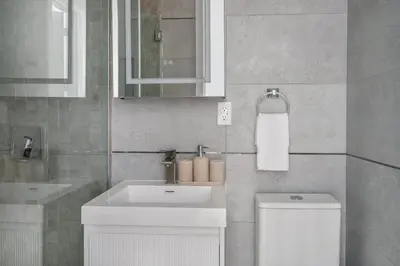 a bathroom with a white sink and a toilet at 317-4B Brand New Modern 1BR Union Square WD in Unit in New York