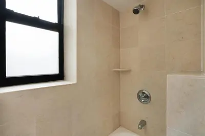 a bathroom with a shower with a window at Mott-9 Prime Soho Cozy New Studio WD in the unit in New York