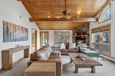 a living room with a couch and a table at Entire Chalet in Windham NY in Maplecrest