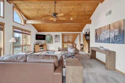 a living room with a couch and a ceiling fan at Entire Chalet in Windham NY in Maplecrest