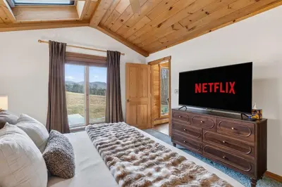 a living room with a television on a dresser at Entire Chalet in Windham NY in Maplecrest