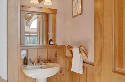a bathroom with a sink and a mirror at Entire Chalet in Windham NY in Maplecrest