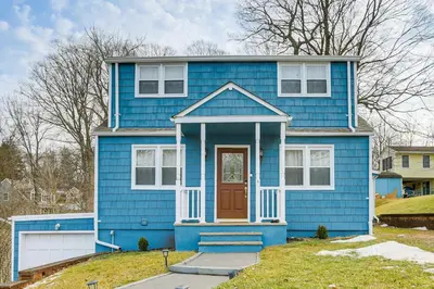 a blue house with a brown door at Walk to Lake Hopatcong Vibrant Home with Deck! in Hopatcong