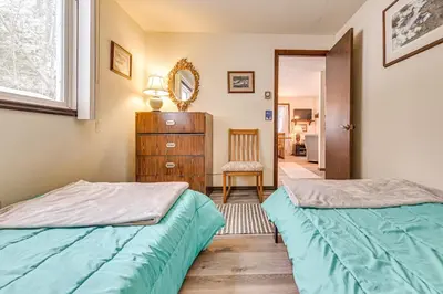 a bedroom with two beds and a dresser at 3 Mi to Windham Mountain Pet-Friendly Apt with Yard in Hensonville