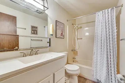 a white bathroom with a sink and a toilet at 3 Mi to Windham Mountain Pet-Friendly Apt with Yard in Hensonville